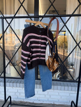 Elle black and pink striped cardigan sweater displayed on a hanger