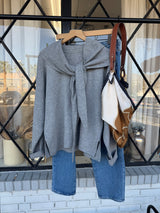 Traditional Girl gray knit top on a hanger showing the front tie detail