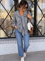 Traditional Girl gray long-sleeve knit top with shoulder-drape tie detail styled with jeans